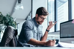 Man working at company, on his phone